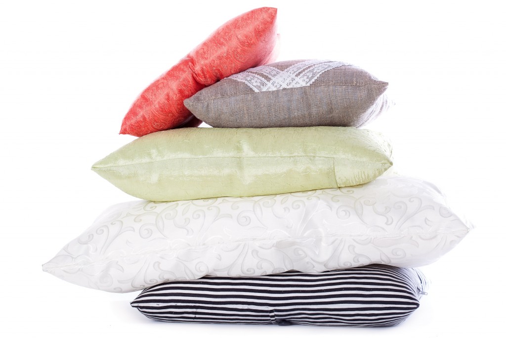 A stack of different pillows. Isolated on a white background